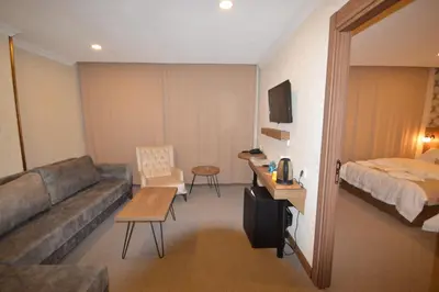 a hotel room with a couch and a bed at Arsisa in Avcılar