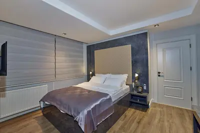 a bedroom with a large bed and a tv at The Bold Hotel in Istanbul