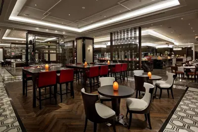 a restaurant with tables and chairs and a bar at Hilton Istanbul Bomonti in Istanbul