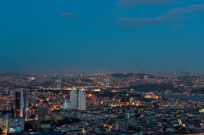 a view of a city at night with lights at Hilton Istanbul Bomonti in Istanbul