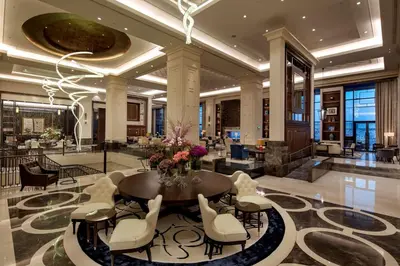 a lobby with a table and chairs in a building at Hilton Istanbul Bomonti in Istanbul
