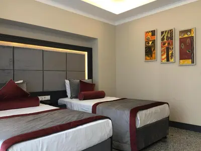 a hotel room with two beds and a window at GRAND MEDYA HOTEL-OLDTOWN in Istanbul
