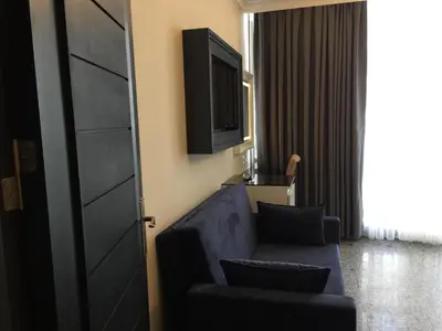 a living room with a couch and a television at GRAND MEDYA HOTEL-OLDTOWN in Istanbul