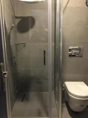 a bathroom with a glass shower with a toilet at GRAND MEDYA HOTEL-OLDTOWN in Istanbul