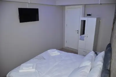 a small bedroom with a bed and a flat screen tv at Rodion Hotel in Istanbul