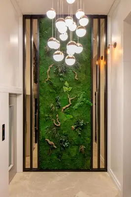 a painting on the wall in a hallway with a chandelier at The Rooms Nisantasi in Istanbul