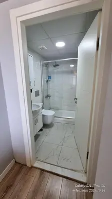 a bathroom with a shower and a toilet and a sink at VESTA RESORT BUTİK HOTEL in Istanbul