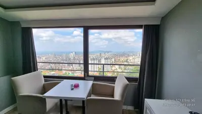 a room with a table and chairs and a large window at VESTA RESORT BUTİK HOTEL in Istanbul