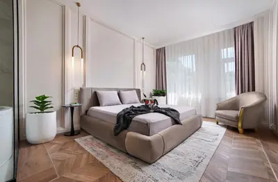 a bedroom with a bed and a couch and a chair at Walton Gardens Pera in Istanbul