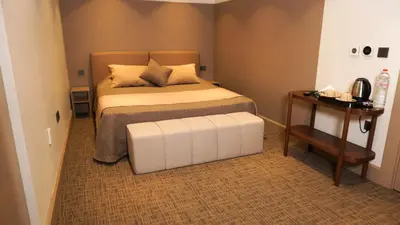 a small bedroom with a bed and a table at Selini Hotel İstanbul Airport in Istanbul