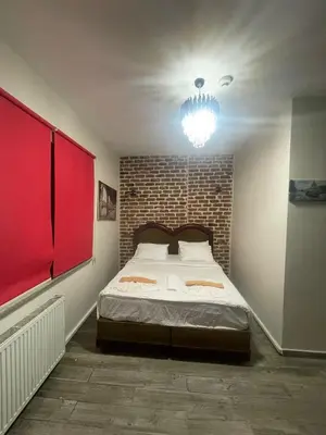 a bedroom with a bed with a brick wall at GRAND BELLA VİSTA Hostel in Istanbul
