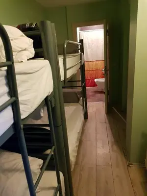 a room with several bunk beds and a bathroom at GRAND BELLA VİSTA Hostel in Istanbul