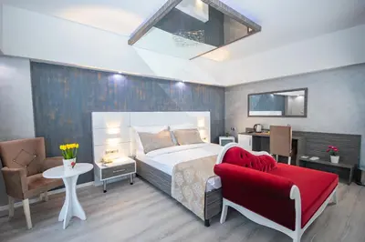 a bedroom with a bed and a red chair at MOX Hotel Wellness & Spa in Sapanca