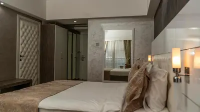 a bedroom with a large bed and a mirror at MOX Hotel Wellness & Spa in Sapanca