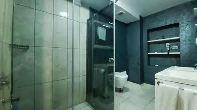 a bathroom with a shower and a toilet and a sink at MOX Hotel Wellness & Spa in Sapanca
