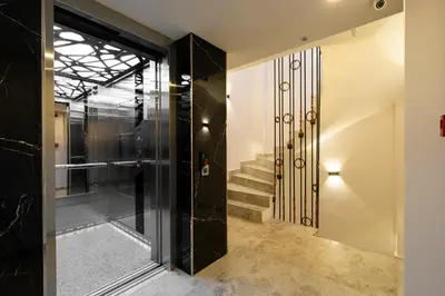 a hallway with a glass door and stairs at Castillo Rojo Hotel Istanbul in Istanbul
