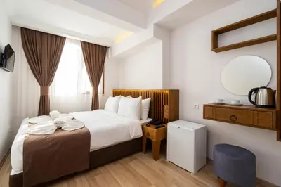 a hotel room with a bed and a mirror at Castillo Rojo Hotel Istanbul in Istanbul