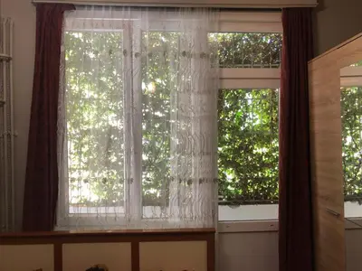 two windows with white curtains in a room at Bahaus Guest House Hostel Near Sultanahmet & Agia Sofia in Istanbul