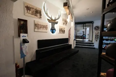 a living room with stairs and a antlers on the wall at Oksijen Zone Hotel & Spa - Full Board Plus in Uludag