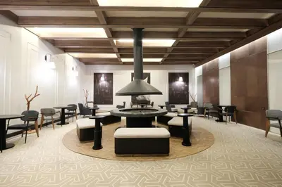 a lobby with a waiting area with tables and chairs at Oksijen Zone Hotel & Spa - Full Board Plus in Uludag