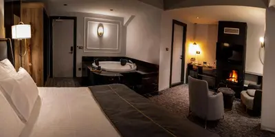 a bedroom with a bed and a bathroom with a sink at Oksijen Zone Hotel & Spa - Full Board Plus in Uludag