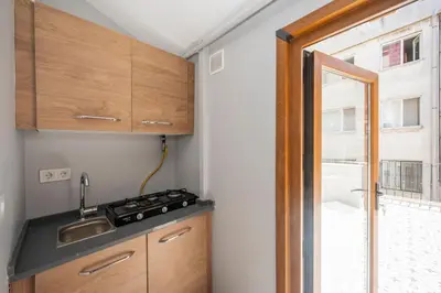 a small kitchen with a sink and a window at Taksim suıte in Istanbul