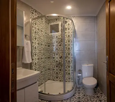 a bathroom with a shower and a toilet and a sink at Taksim suıte in Istanbul