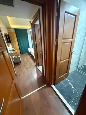 a hallway with an open door and a room at Pege Hotel in Istanbul