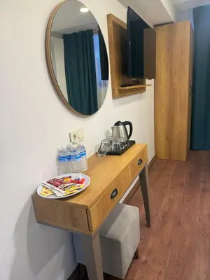 a dressing table in a room with a mirror at Pege Hotel in Istanbul