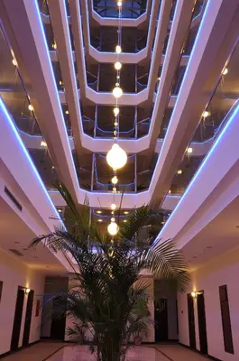 a ceiling with lights and a plant in a lobby at İğneada Resort Hotel & SPA in Igneada