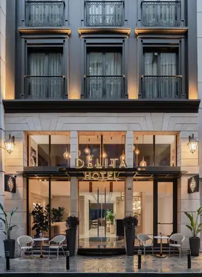 a hotel with tables and chairs in front of a building at Delita City Hotel in Istanbul