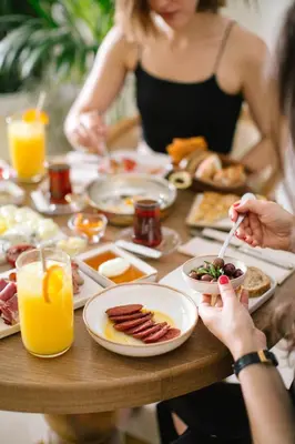 a group of people sitting at a table eating breakfast at Delita City Hotel in Istanbul