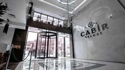 a lobby of a building with a sign on the wall at Cabir Deluxe Hotel Sapanca in Sapanca