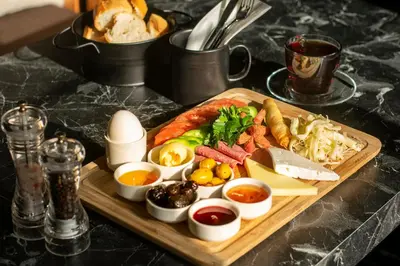 a tray of food with different types of food on a table at Hotel Bossuite Business in Istanbul