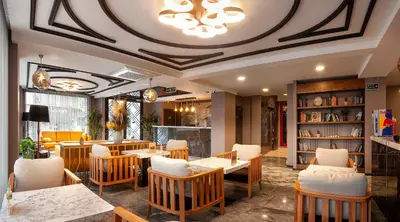 a restaurant with tables and chairs and a ceiling at Hotel Bossuite Business in Istanbul