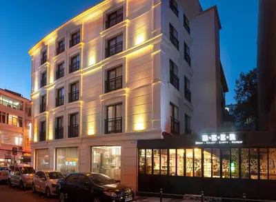 a white building with cars parked in front of it at Hotel Bossuite Business in Istanbul