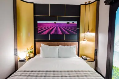a bedroom with a bed with a tv above it at Dosso Dossi Hotels Laleli in Istanbul