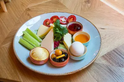 a plate of food with fruits and vegetables and eggs at Dosso Dossi Hotels Laleli in Istanbul