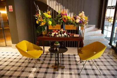 two yellow chairs in front of a table with flowers at Dosso Dossi Hotels Laleli in Istanbul
