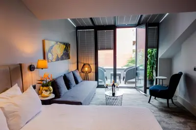 a bedroom with a bed and a couch at Dosso Dossi Hotels Laleli in Istanbul