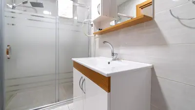 a white bathroom with a sink and a shower at Best Hotel Pendik in Istanbul