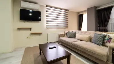 a living room with a couch and a tv at Best Hotel Pendik in Istanbul