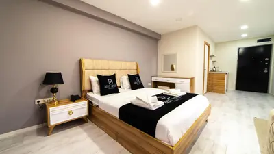 a bedroom with a large bed with black and white pillows at Best Hotel Pendik in Istanbul