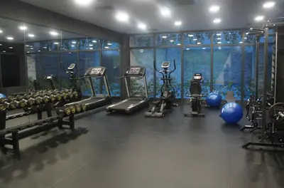 a gym with several exercise equipment in a room at Sakarya Hotel in Sakarya