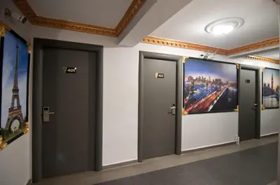 a row of elevators in a building with paintings on the walls at Golden Horn Park Hotel in Istanbul
