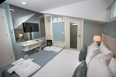 a bedroom with a large bed and a sink in it at Ravvda Hotel in Istanbul