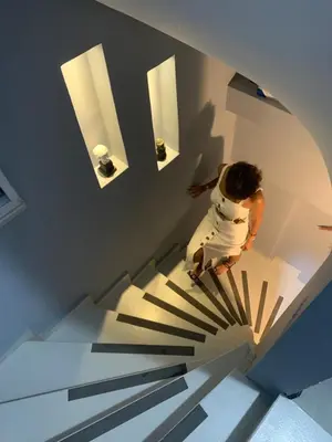 a person walking down a staircase in a house at Valeria House in Istanbul