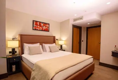 a bedroom with a large bed and two lamps at Root Hotel Karaköy Bosphorus in Istanbul