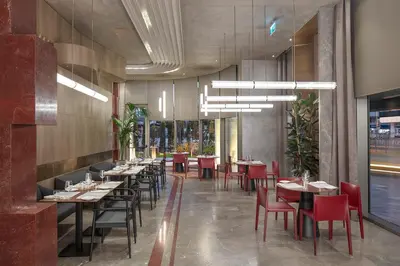 a dining room with tables and red chairs at Melas Hotel Istanbul in Istanbul