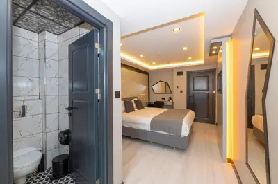 a hotel room with a bed and a bathroom at White Corner Hotel in Istanbul